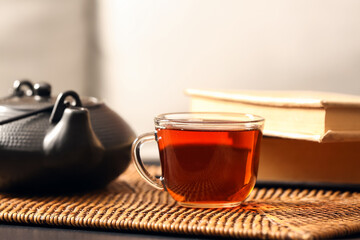 Glass cup of tasty tea on table in cafe