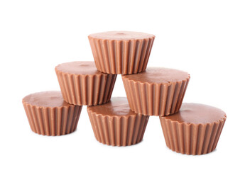 Tasty peanut butter cups on white background
