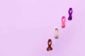 Different awareness ribbons on lilac background. World Cancer Day