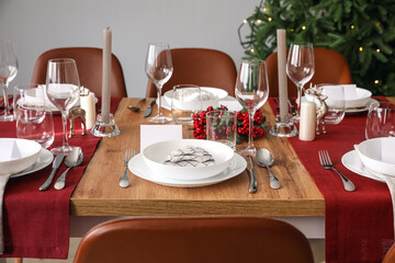 Festive table setting for Christmas celebration in dining room