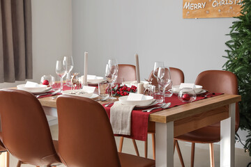 Festive table setting for Christmas celebration in dining room
