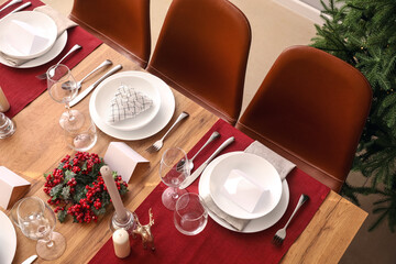 Festive table setting for Christmas celebration in dining room