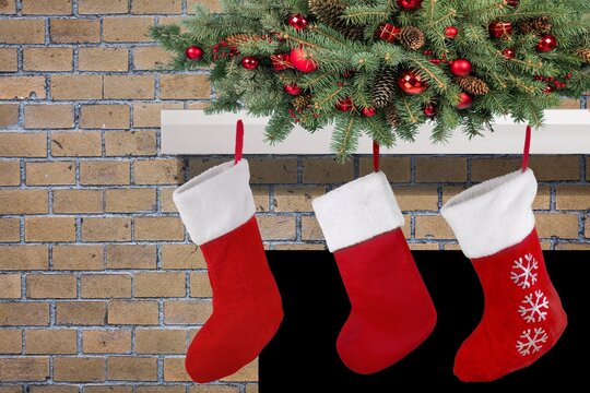 Three Red Christmas Stockings On Fireplace Mantle