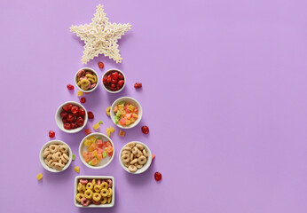 Christmas tree made of snacks on color background