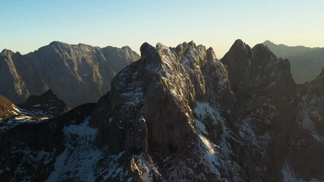 Rotating drone shot of the snow covered Mangart mountain in the Julian Alps in Slovenia
