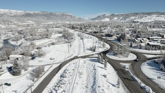 Flying over a round about in the town of Eagle with fresh snow during the month of December. Filmed in the Rocky Mountains of Colorado near the town of Eagle along Interstate 70.