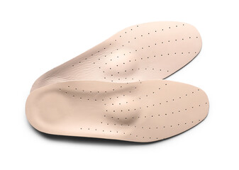 Beige orthopedic insoles on white background