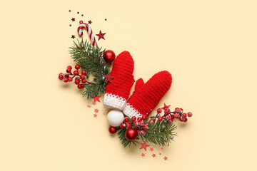 Beautiful Christmas composition with decor and mittens on yellow background