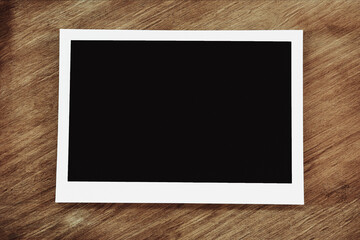 Picture frame mockup design. Empty photo on wooden background.