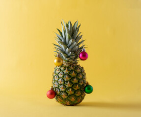 Christmas tree made of pineapple and christmas bauble decoration. Holiday concept.