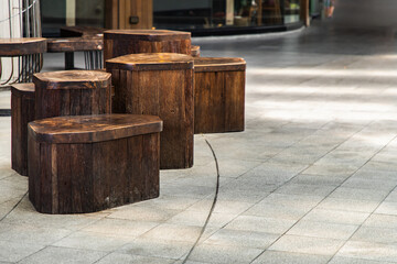 Table and benches set made of wooden on leisure corner. Concept of Place to sit and relax, design furniture made of wooden, Copy space, Selective focus.