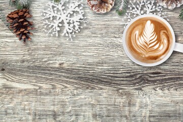 Welcome 2021 theme coffee cup on wooden table with dried pine branches. Happy new year 2021, Holidays food art concept.