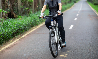 Fototapeta na wymiar Riding a bike on tropical park trail