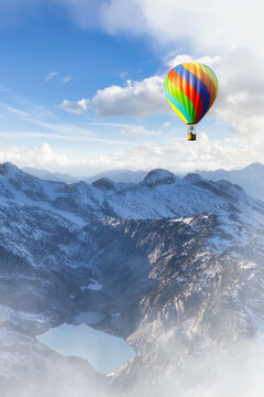 Dramatic Mountain Landscape covered in clouds and Hot Air Balloon Flying. 3d Rendering Adventure Dream Concept Artwork. Aerial Image from British Columbia, Canada.