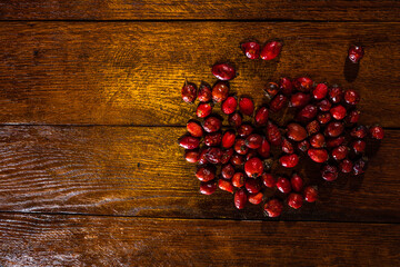 Close-up shot of dried rosehips on a wooden table