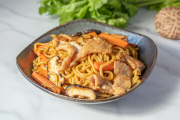 Udon stir fry noodles teriyaki sauce with pork meat and vegetables shiitake mushrooms