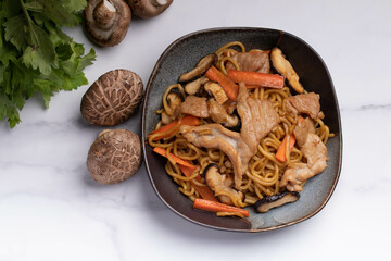 Udon stir fry noodles teriyaki sauce with pork meat and vegetables shiitake mushrooms