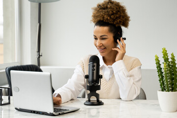 Young black woman is making an online podcast recording for her online show. An attractive...