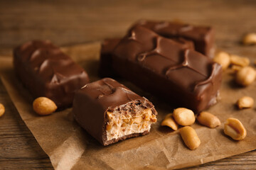 Chocolate bars with caramel, nuts and nougat on table, closeup