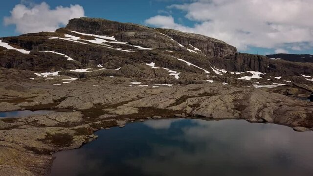 Aerial footage of the snowy and rocky mountains near Trolltunga in Norway.