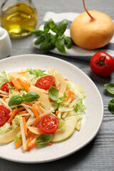 Delicious turnip salad served on grey wooden table, closeup