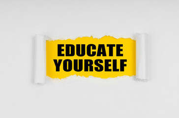 A window is made in the paper, where on a yellow background the inscription - Educate Yourself