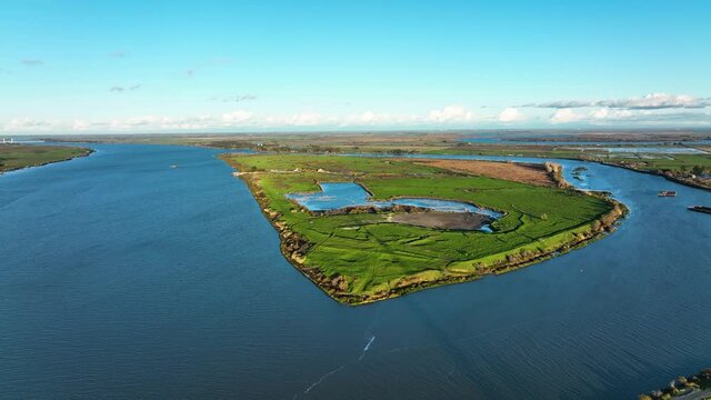 Aerial view of Sherman island green pastures along the Sacramento-San Joaquin Delta river, Northern California