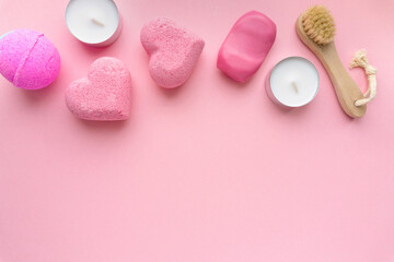 Valentine's day flat lay. Bath bombs, soap and candles on pink background, space for text
