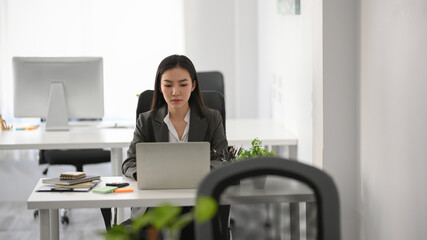Asian businesswoman working at her office desk.