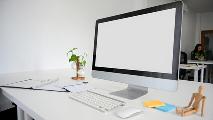 Modern office desk with desktop computer and office supplies.
