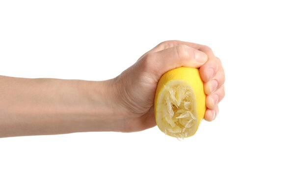 Woman squeezing lemon half on white background, closeup