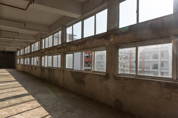 Abandoned factory interior with glass windows and passages