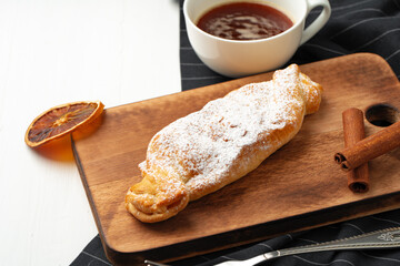Traditional apple strudel on wooden board, close up
