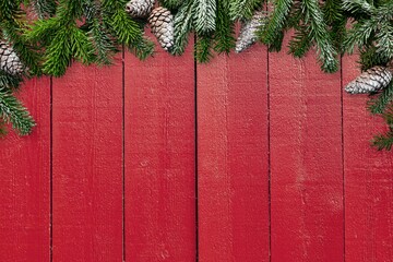 Christmas fir branch and decorations on wooden background.