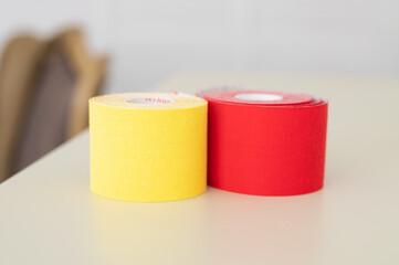 Set with different color kinesio tapes on pastel background. Kinesiology, physical therapy, rehabilitation concept