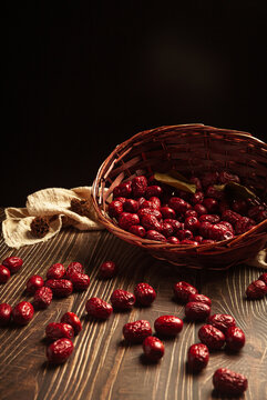 red dried jujube in a basket on wooden table
