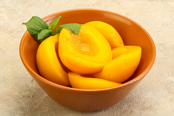 Sweet ripe canned peaches with mint