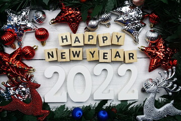 Happy New Year 2022 alphabet letters and christmas decoration on wooden background