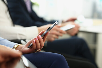 Female hands with manicure hold mobile phone device