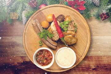 Christmas meat dish. Festive decorated wooden table for Christmas Dinner