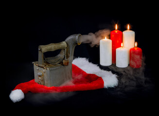 Iron on a black background, vintage, Christmas, Santa Claus hat, Christmas candles