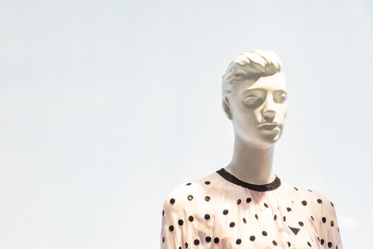 human female mannequin portrait photograph in showcase display of the fashion clothes store. copy space for text