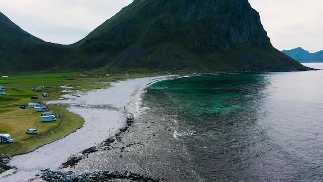 Aerial drone view approaching the Uttakleiv beach, in cloudy Lofoten, Norway