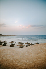 Vertical shot of the Red sea at the Marsa Alam beach with sunbeds at sunset in Egypt