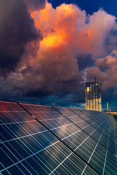 Building roof with solar panels under a cloudy sunset sky in Klaipeda, Lith