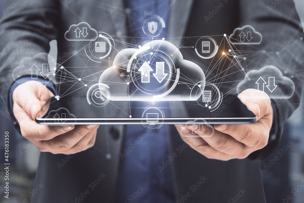 Aufkleber Close up of businessman hands holding tablet with abstract glowing cloud computing hologram with download/upload arrows on blurry city background. Database, technology and future concept. 