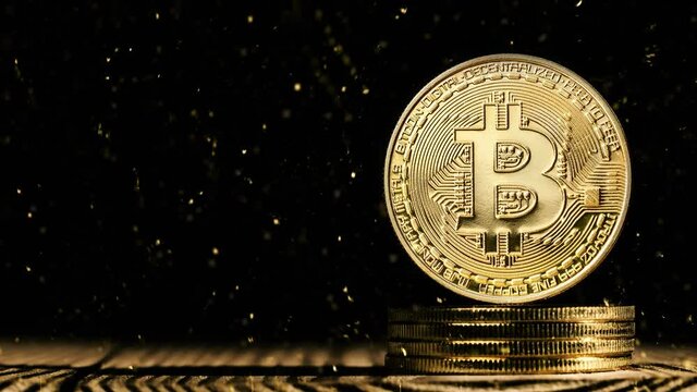 golden snow falling on bitcoin on black black background