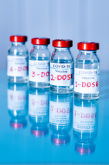 multiple doses of covid-19 or coronavirus vaccines on table for vaccination to protect againt...