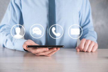 Businessman hand holding,pressing on icon phone, mail, telephone,message,post and person,user. Customer service call center contact us concept.Banner,copy space.Contact Methods.
