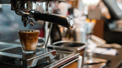 black coffee with milk on a coffee maker